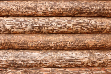 textured wall of a wooden house made of cedar logs