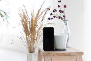 Coffemug with smartphone and dryflowers