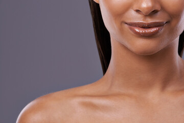 Closeup, lipstick and woman with skincare, cosmetics and dermatology on grey studio background....
