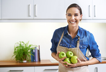 Happy woman, portrait and kitchen with apple for nutrition, natural diet or healthy eating at home....