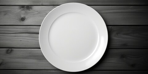 A simple white plate on a rustic wooden table. Suitable for food and kitchen-related designs