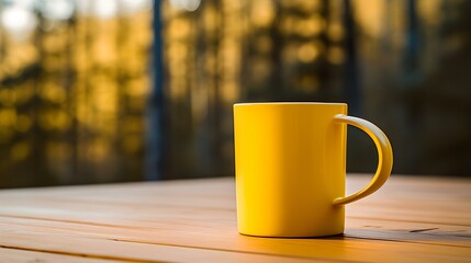 Close up of a yellow Mug on a wooden Table in a Forest. Blurred natural Background