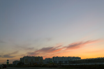 Silhouettes of houses at dusk against a beautiful evening sky at sunset