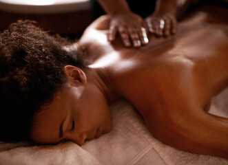 Obraz na płótnie Canvas Massage, relax and wellness with black woman at spa on bed or table for luxury pamper treatment. Beauty, peace and therapy with back of young customer at resort or salon for holistic healing closeup