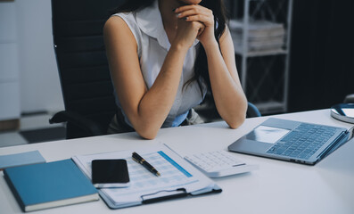 Asian women are stressed while working on laptop, Tired asian businesswoman with headache at office, feeling sick at work, copy space