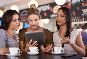 Woman, together and read at coffee shop with tablet for online menu or restaurant review, diversity and relax for leisure. Female friends, digital technology and internet to search or browse website. - Powered by Adobe