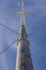 power line on a concrete pole against a blue sky
