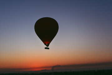 Many Hot air balloons at sunrise floating over the Nile River in Luxor, Egypt