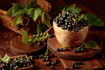 Ripe black currant on a brown table.