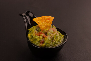 Guacamole in a Bowl, is an Avocado Based Dip, Spread, or Salad from Mexico.