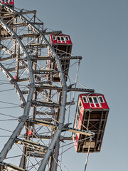 Wiener Riesenrad in Vienna, Austria. Historic tall Ferris wheel with red gondolas at the entrance of the Prater amusement park. 