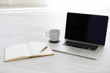 Notebook with pen, smartphone and laptop