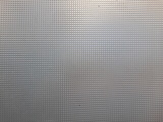 the texture of a fiber covering a fence in a daytime photo