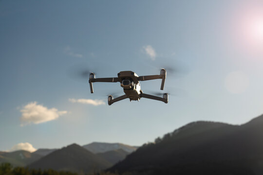 Drone with camera flying over the mountains