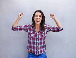 Portrait, celebration and woman with news, excited and announcement on grey background. Face,...