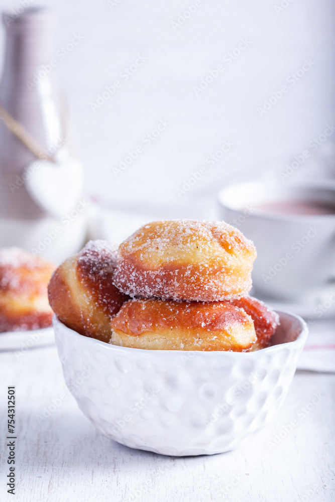 Wall mural Donuts with sugar and cinnamon served with cocoa. Traditional dessert for Carnival.