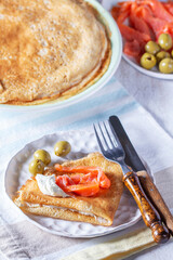 Pancakes with gravlax, cottage cheese and olives. A traditional dish for Maslenitsa or Carnival. - 754312967