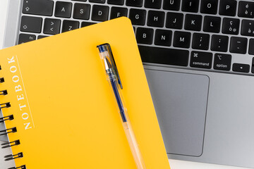 Laptop with block notes and pen