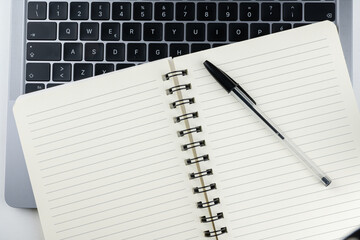 Laptop with block notes and pen