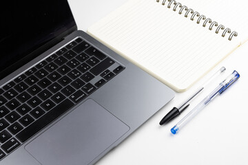 Laptop with block notes and pen