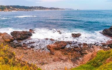Punta Playa Cometa sunset panorama view mountains rocks Mazunte Mexico.