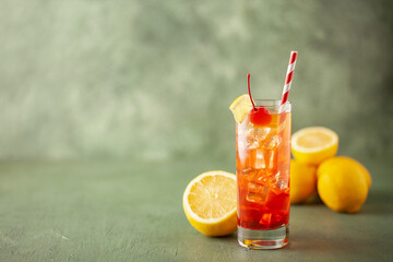 Fresh summer cocktail limoncello sunrise in a glass with lemon and  cherries