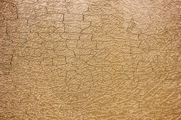 Natural background made of broken yellow glass with cracks