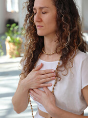 Yoga Woman Meditating, holding hands on the Heart portrait. Loving Kindness Meditation, Self-love , Gratitude concept