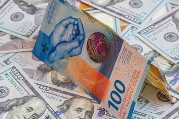 Closeup of 100  Swiss franc and 100 dollar banknotes