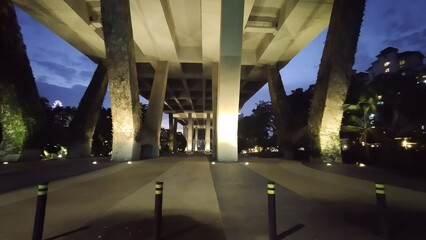underside of a huge bridge turned into a well-lit park