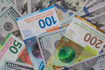 Closeup of 50, 100 and 200 Swiss franc banknotes and 100 dollar banknote