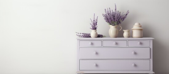 A white dresser is shown with three vases placed neatly on top. The dresser is clean and modern in design, with the vases adding a touch of decoration to the surface.