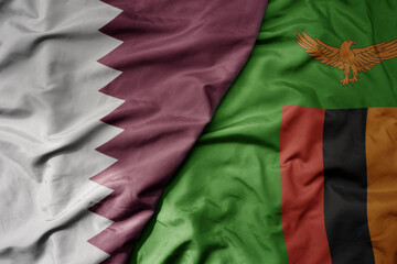 big waving national colorful flag of zambia and national flag of qatar.