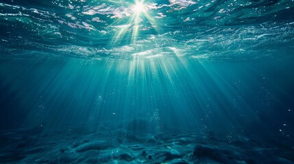 Underwater view with sunbeams shining through the ocean's surface, creating a serene and ethereal...