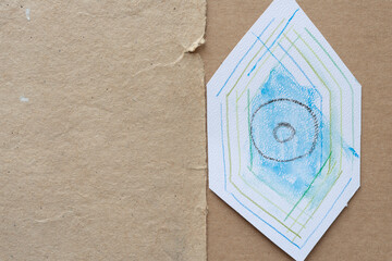 abstract hexagonal shape with circles and lines on cardboard