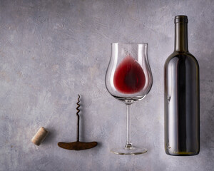 Still life. Glass with red wine and bottle on textured background. - 754337982
