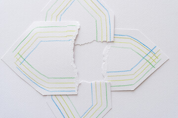 torn in half abstract hexagonal shapes on textured paper