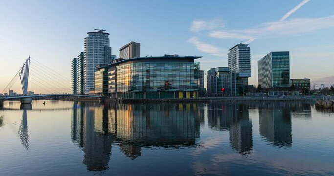 Salford Quays time lapse video showing a transaction between day to night and building reflection at the waterfront. 