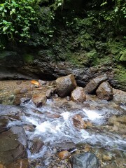 water flowing through rocks on a river in the forest