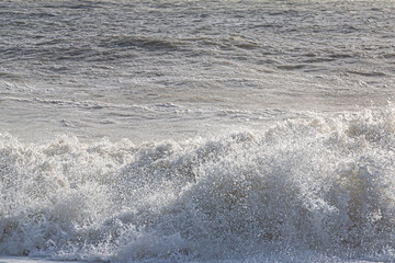 A full frame photograph of crashing waves in the sunshine - 754346383