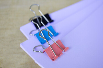 Fototapeta premium Close up of paper clips pastel clipping blank paper. Documentation concept