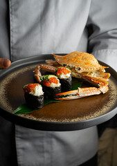 In an upscale restaurant, a beauty enjoys seafood, whiskey, and wine. Kamchatka crab and premium caviar elevate sushi. A tasty octopus is a treat. The bartender and sommelier expertly pair wines 