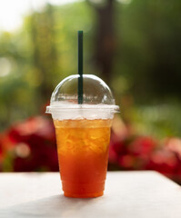 Ice tea lemon on wooden table and nature background