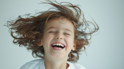 Exuberant child laughing with flying hair, joyous moment captured