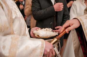Wedding gold rings on a white pillow in the hands of a man