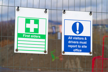Construction site health and safety sign on fence