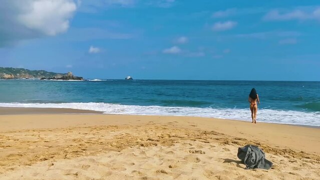 Sexy female tourist traveler woman girl walks swims Mazunte Mexico.