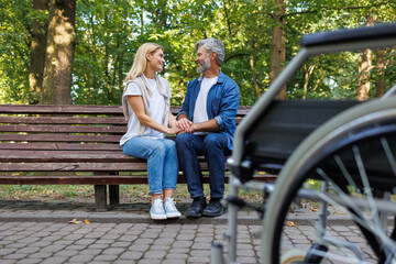 Nature's Embrace: Wheelchair Couple's Tender Park Scene