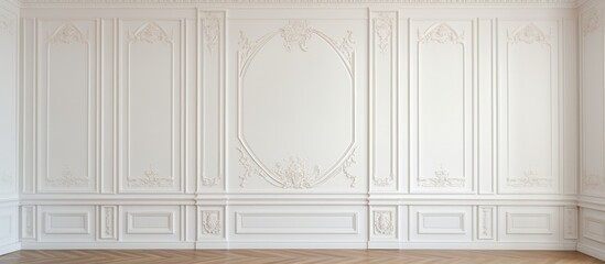 A room with classic white walls and ornate wall panels sits empty, with a large mirror hanging on one wall. The mirror reflects the empty space, creating a sense of openness.