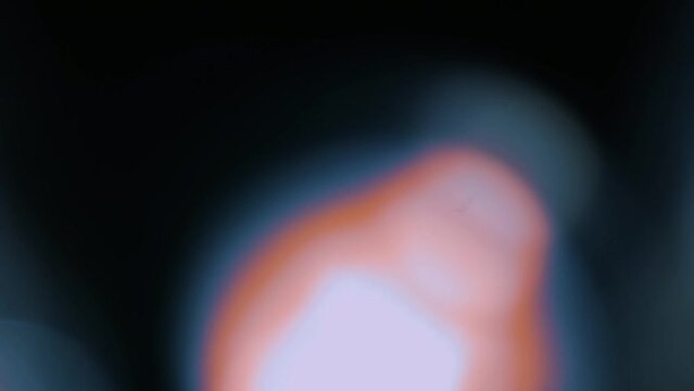 Colorful light leak, lens flare bogeh on dark background. Spectrum, rainbow colors. Motion graphic